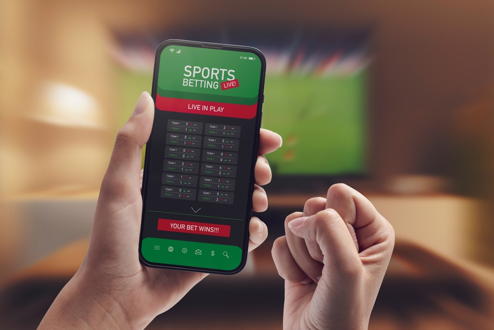 Live,In-play,Betting,App,On,Smartphone,Display,,A,Woman,Is pariurile sportive au evoluat odata cu tehnologia